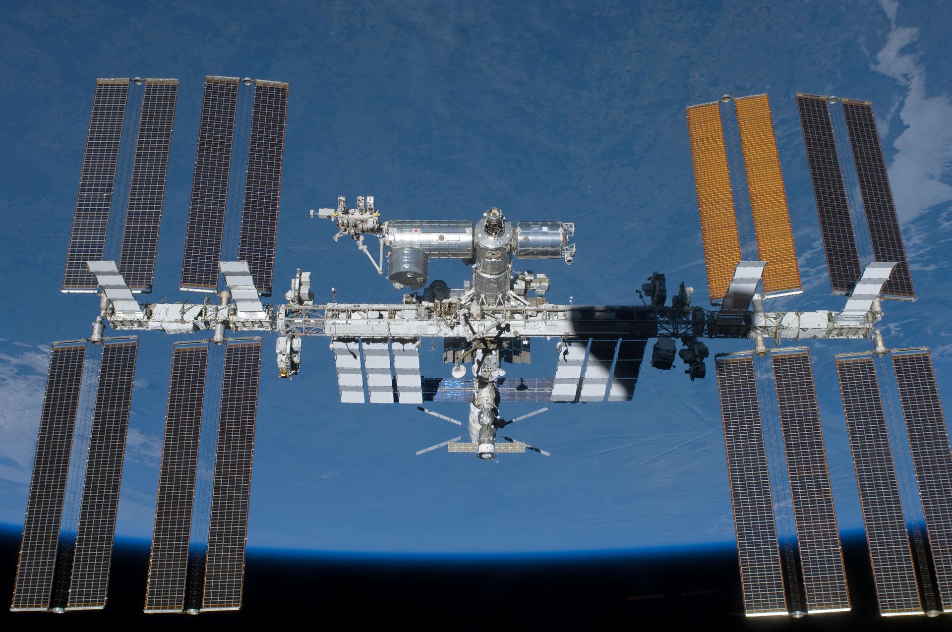 The International Space Station photographed against Earth during a shuttle flyaround in 2011, the same station now scheduled to be deorbited near Point Nemo in 2031
