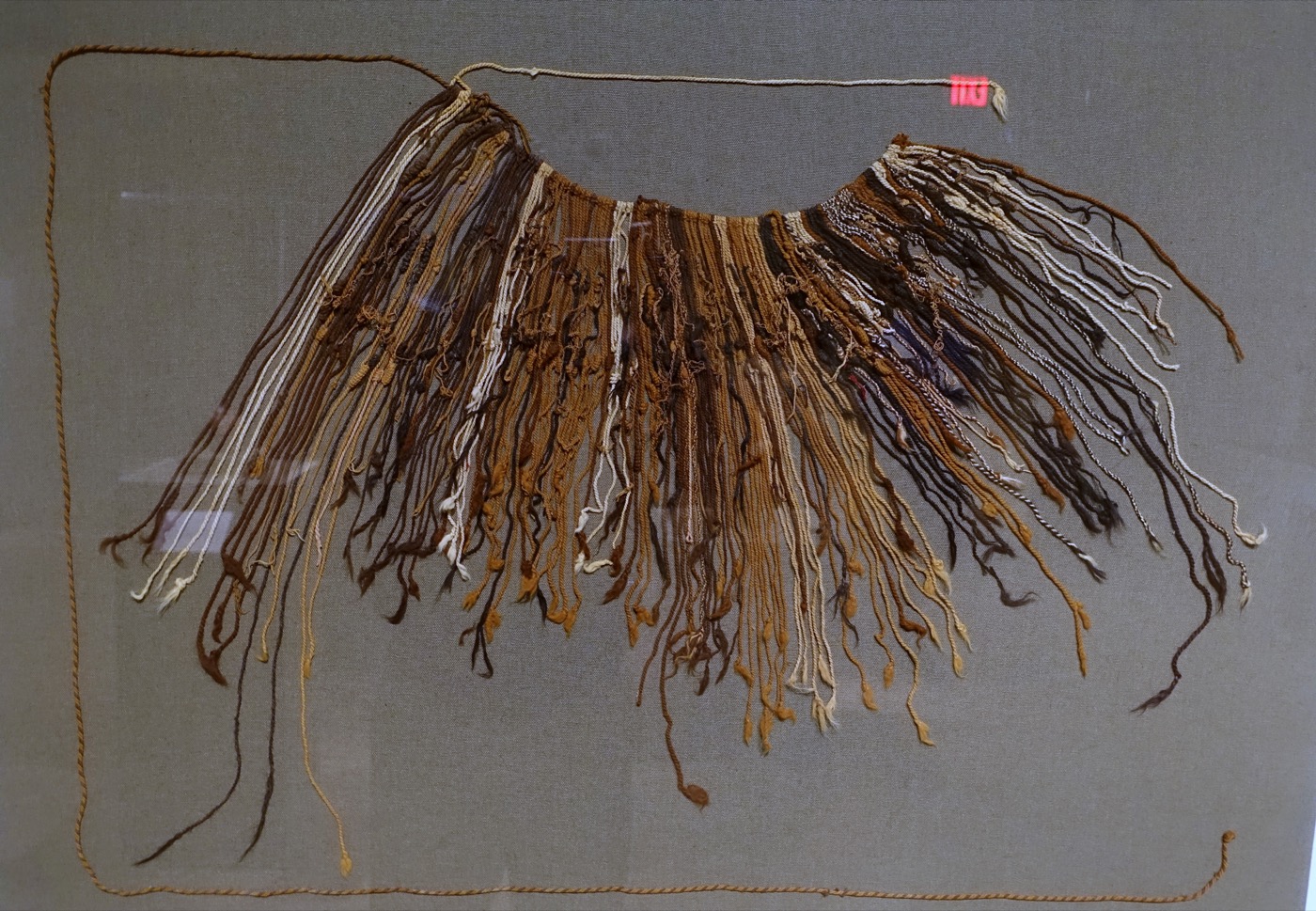 Close-up detail of an Inca quipu showing two main cords with subsidiary and tertiary pendant cords branching off at multiple knotted levels