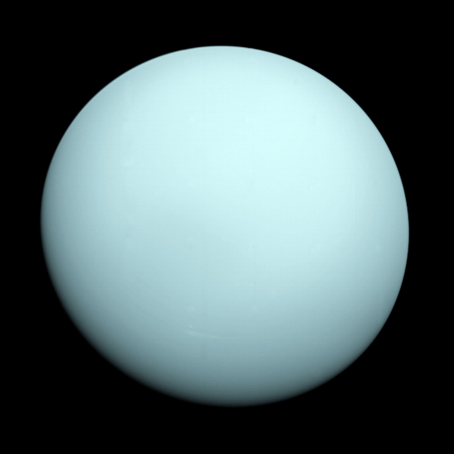 NASA's Voyager 2 false-color image of Uranus, taken during the spacecraft's single 1986 flyby, showing the featureless pale cyan disk that gave the planet its reputation as the solar system's blandest world
